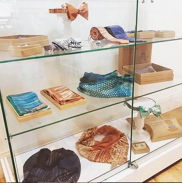 Printed silk accessories in glass display case